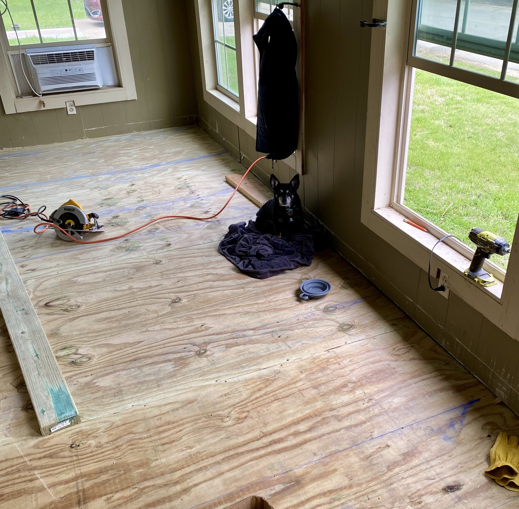 New plywood subfloor installed over the enclosed porch framing