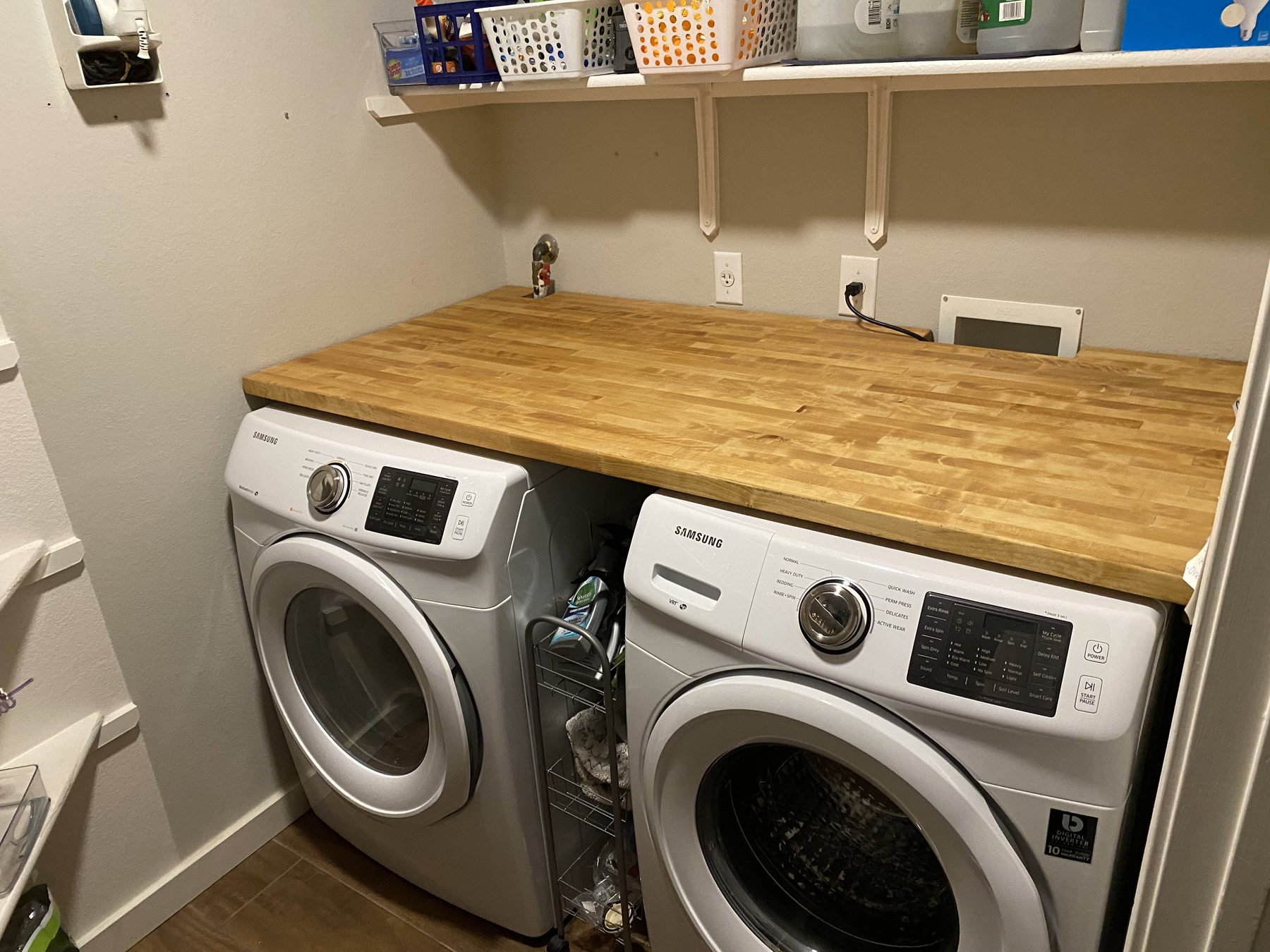 Finished butcher-block work surface installed above a washer and dryer