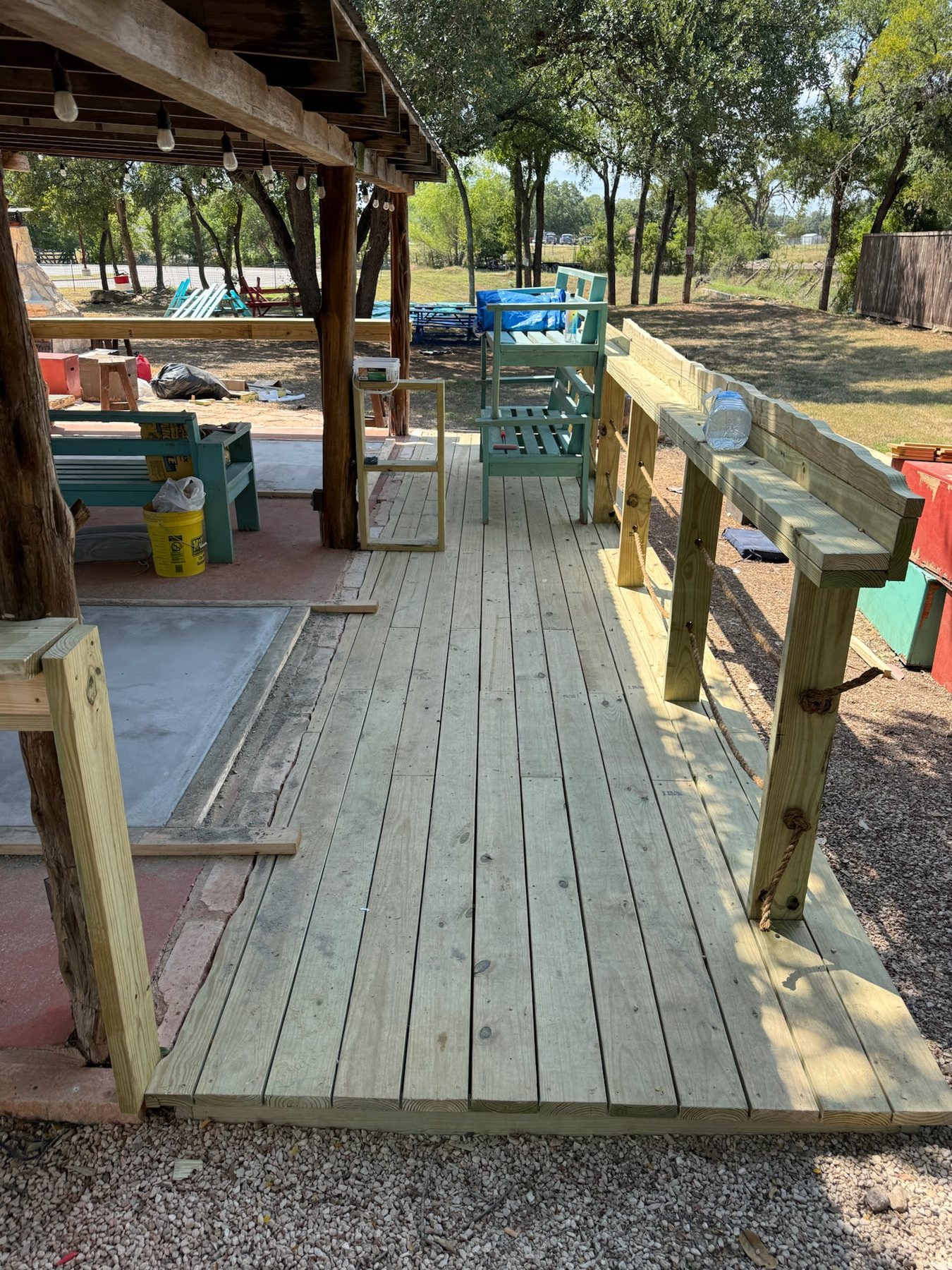 New deck with a custom drink rail beside the shuffleboard court