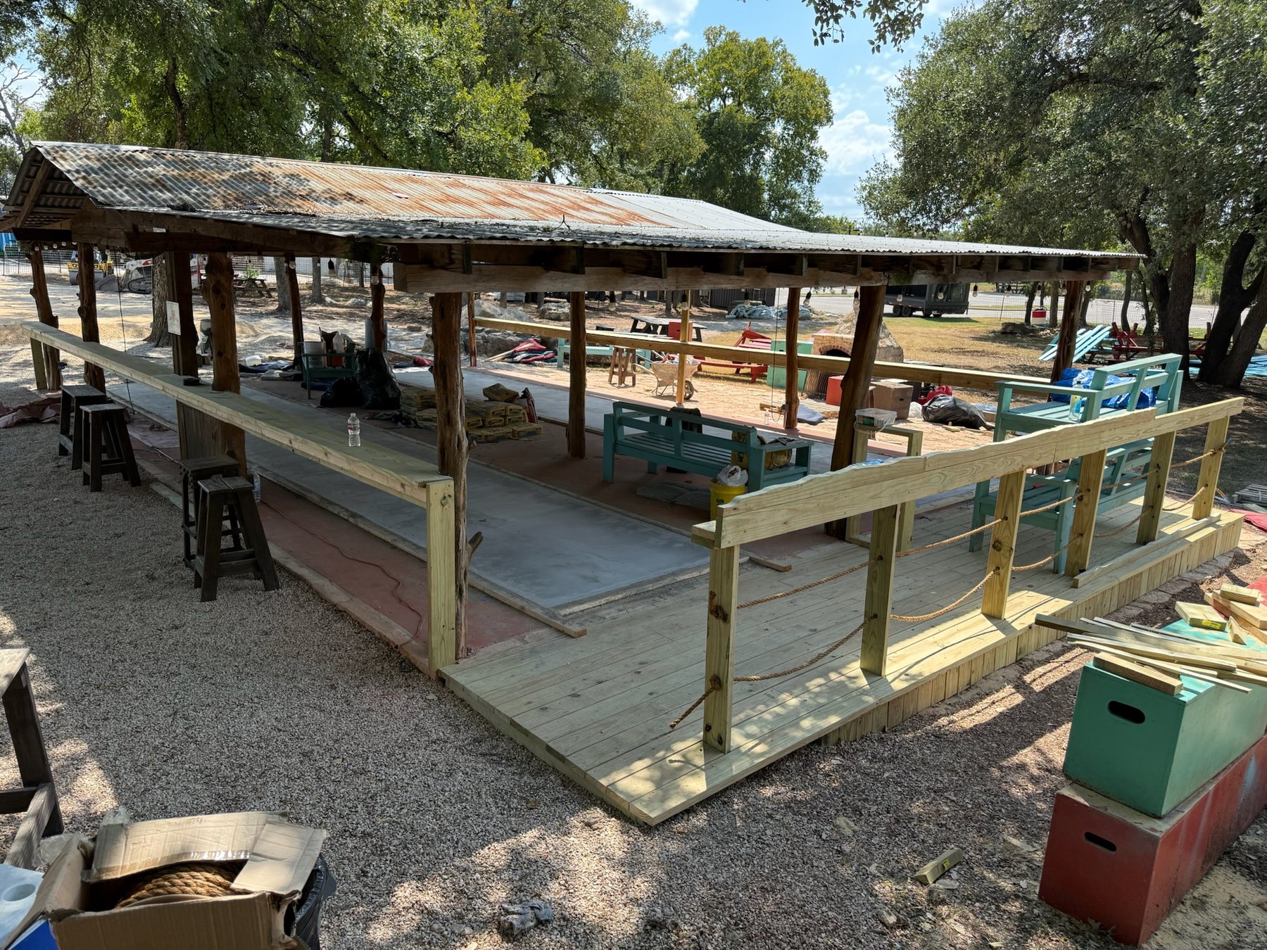 Long custom drink rails spanning both sides of the covered shuffleboard court