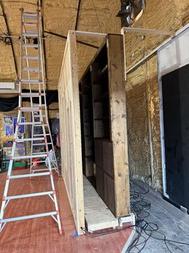 Transforming scenic wall system during installation for The Illusionary Games of Edward Rye