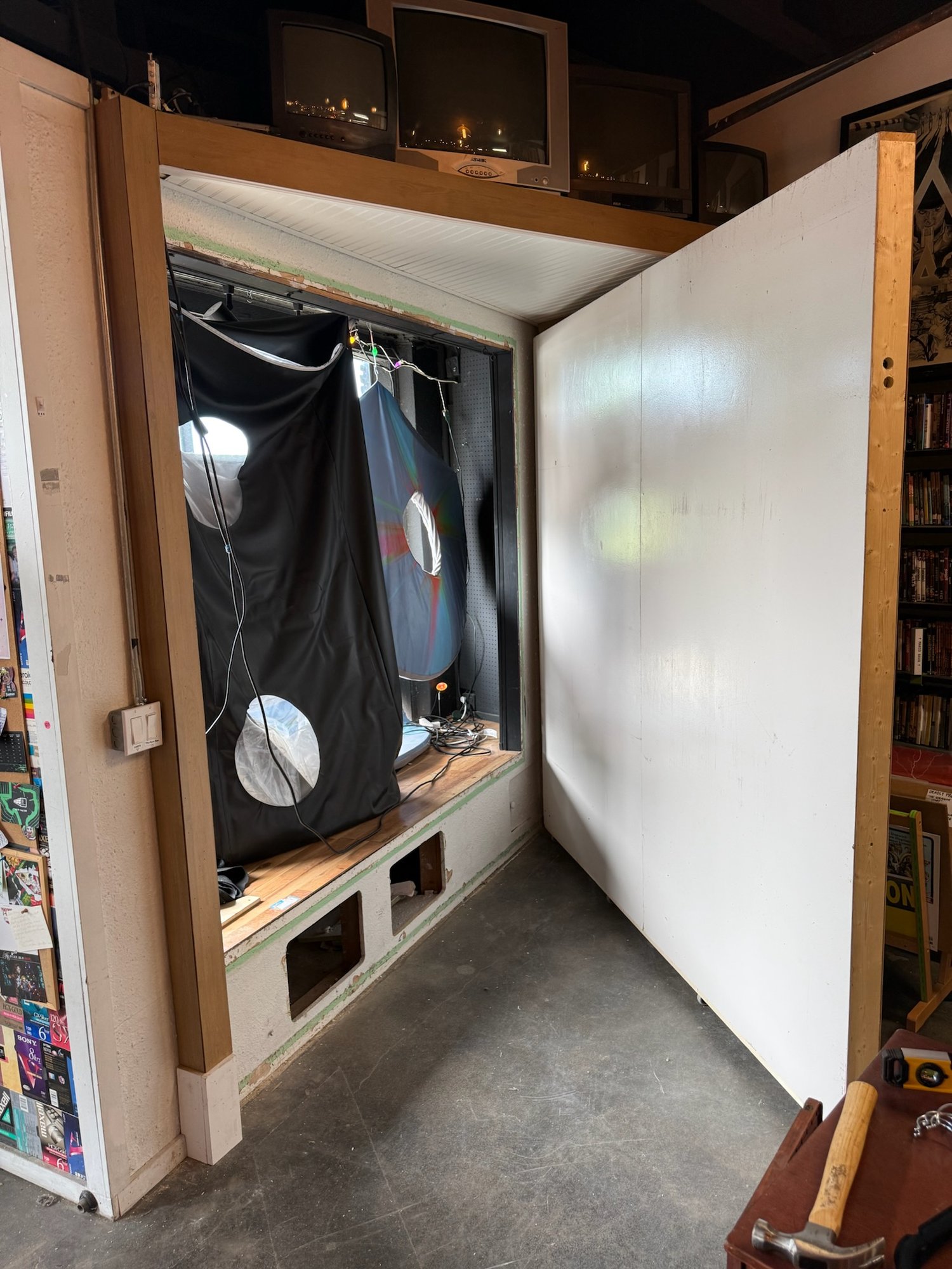 Merchandise wall swung open to access the back of the window display