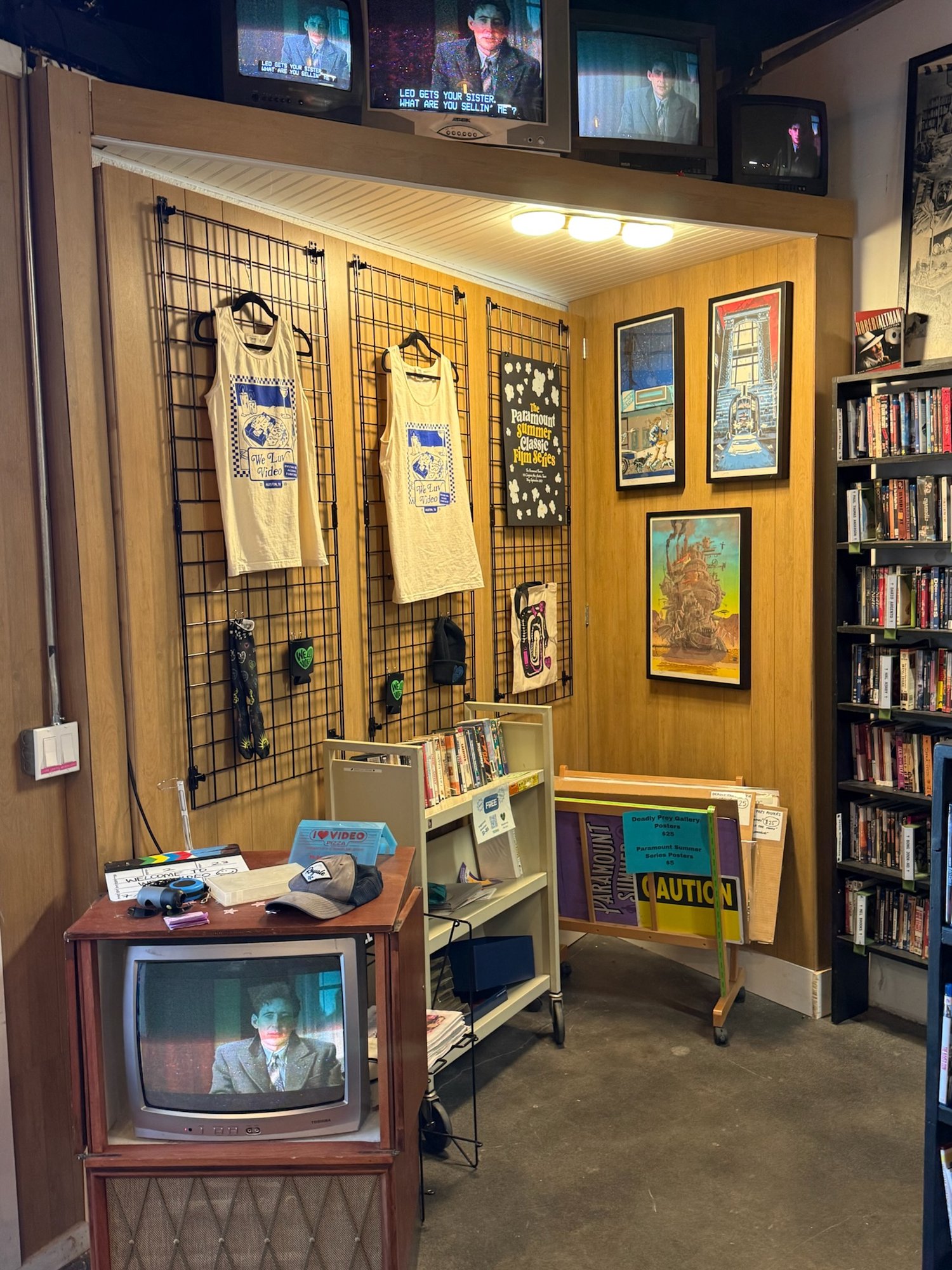 Finished merch wall with television shelf visible above