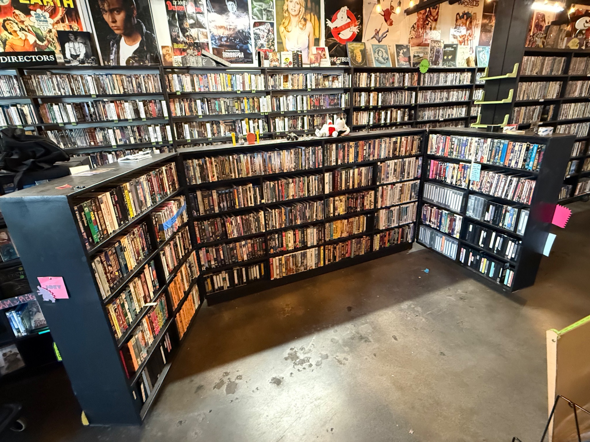 The concealed inventory storage open behind the stocked shelving